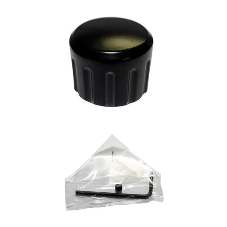 Black cylindrical object and clear plastic triangle with a light bulb on a white background